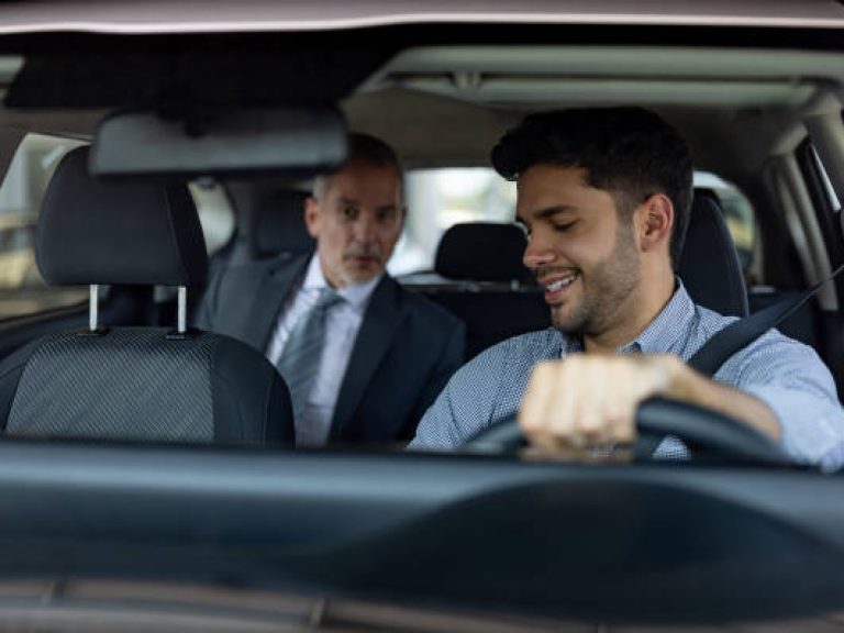 Passenger talking to his crowdsourced taxi driver in the car - transportation concepts