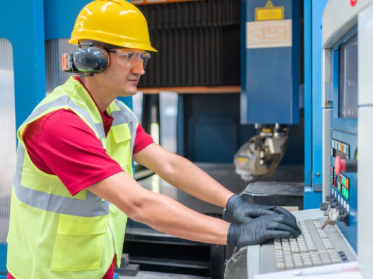 Factory Worker Programming A CNC Machine